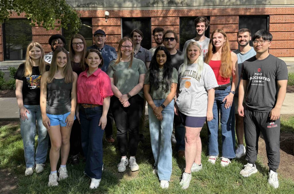Photo of people in the Schultz lab outside under a tree.